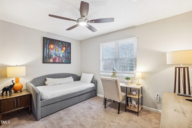 interior space featuring ceiling fan, light carpet, and a textured ceiling