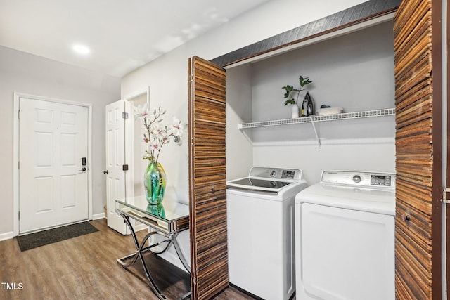 laundry area with washer and clothes dryer and hardwood / wood-style floors