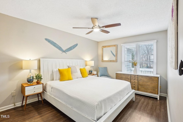 bedroom featuring ceiling fan, dark hardwood / wood-style floors, and a textured ceiling