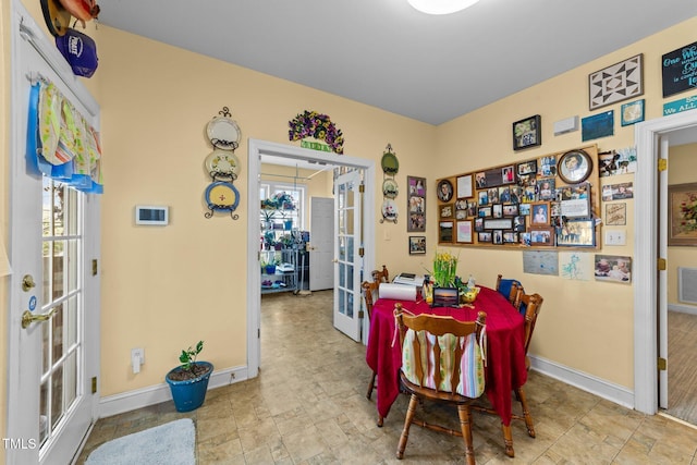 dining room featuring baseboards, visible vents, and french doors