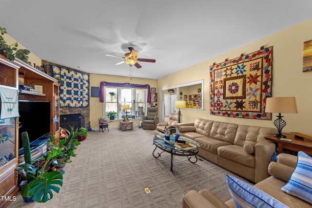 living room featuring light colored carpet, a fireplace, and ceiling fan