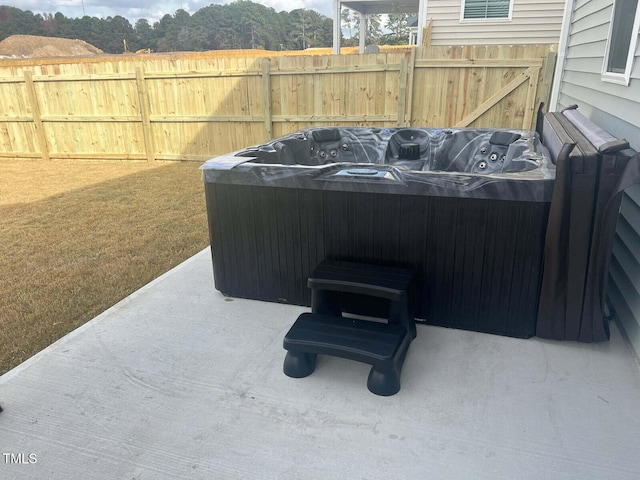 view of patio / terrace with a hot tub