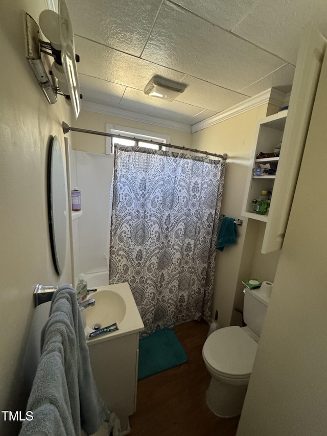 bathroom featuring vanity, crown molding, wood-type flooring, and toilet