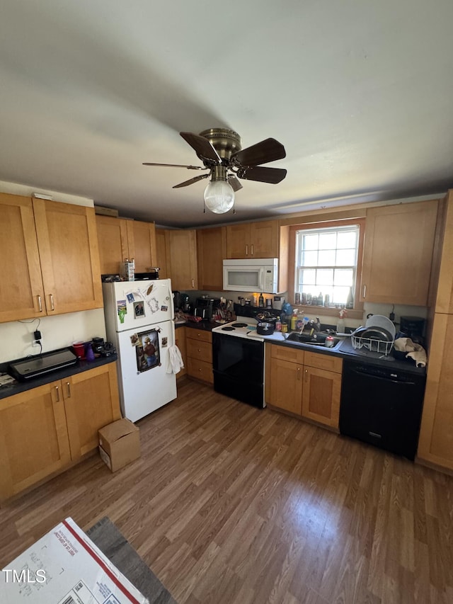 kitchen with dark hardwood / wood-style floors, ceiling fan, sink, and white appliances