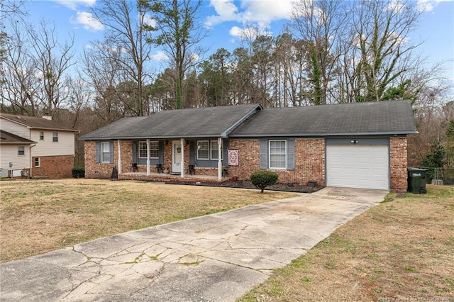 single story home featuring a garage, a front yard, and covered porch