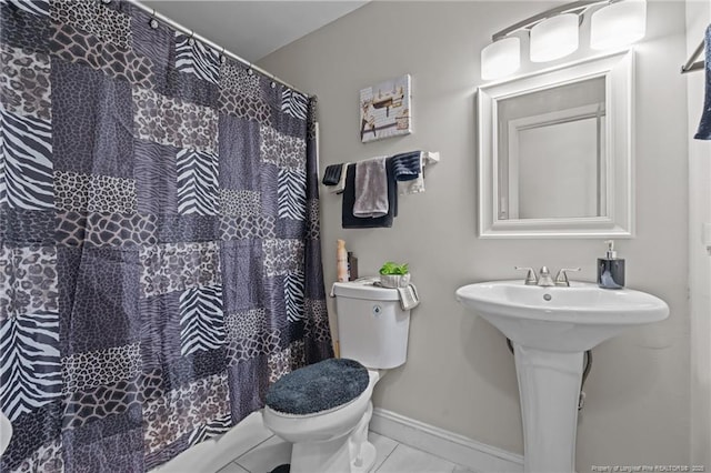 bathroom with tile patterned flooring, sink, and toilet