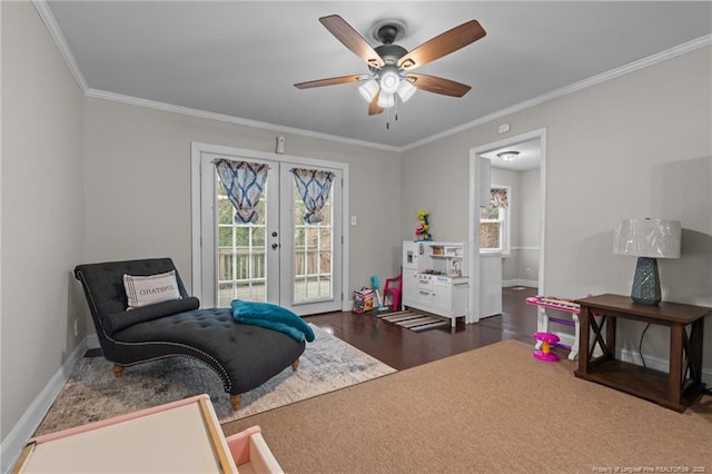 sitting room with french doors, dark hardwood / wood-style floors, crown molding, and ceiling fan