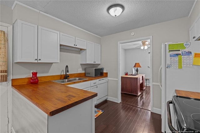 kitchen featuring wood counters, dark hardwood / wood-style floors, sink, and white cabinets