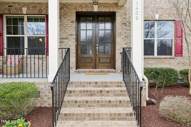 doorway to property with french doors and brick siding