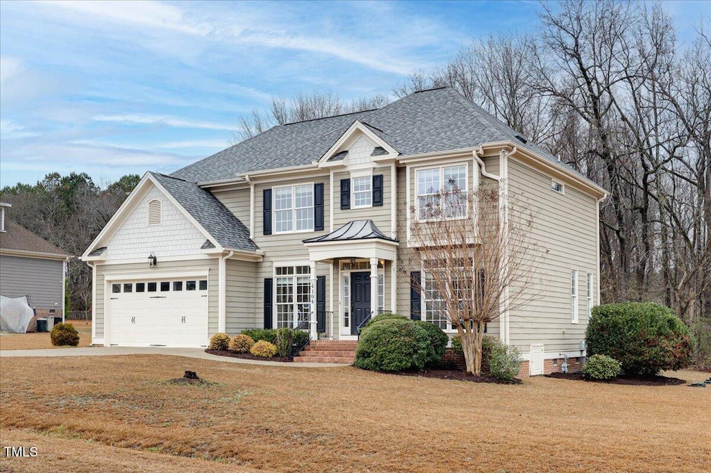 view of front facade with a garage and a front lawn