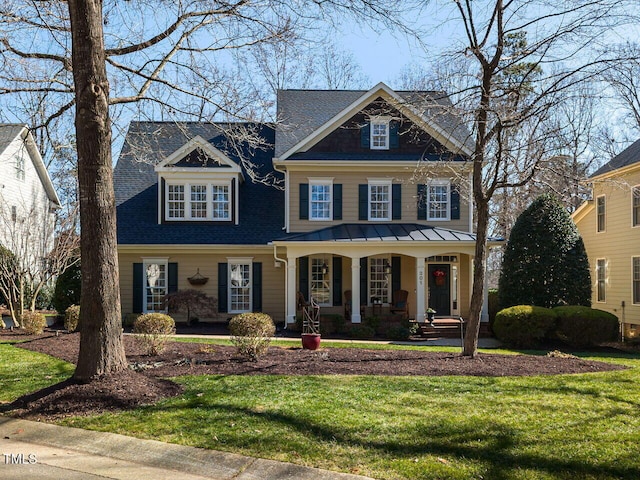 view of front facade with covered porch and a front yard