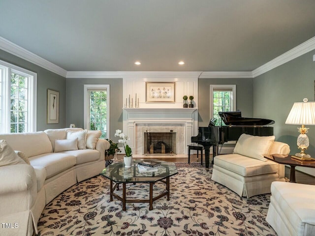 living area featuring ornamental molding, a fireplace, and recessed lighting