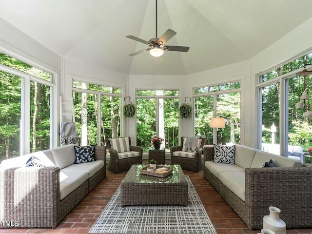 sunroom featuring lofted ceiling and ceiling fan