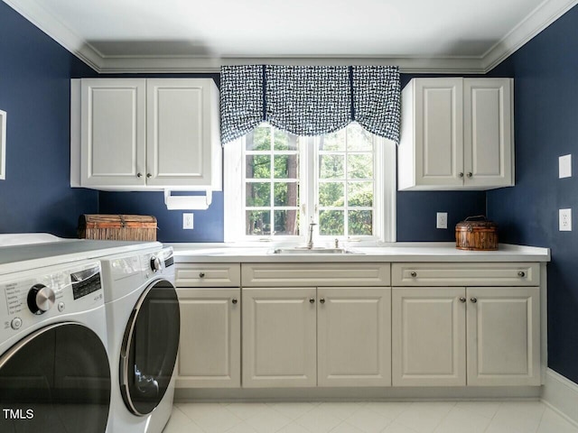 washroom with cabinet space, crown molding, separate washer and dryer, and a sink