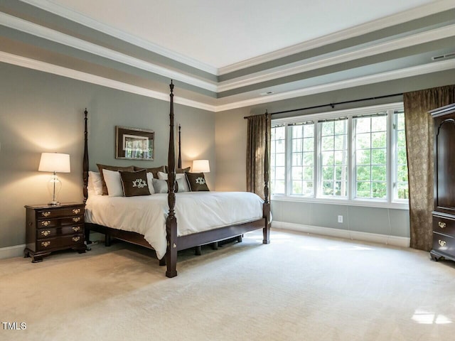 bedroom featuring visible vents, a raised ceiling, baseboards, ornamental molding, and carpet