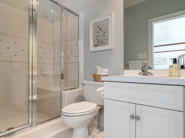 bathroom with toilet, a shower stall, tile patterned flooring, and vanity