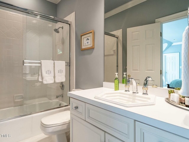 full bathroom with combined bath / shower with glass door, vanity, and toilet