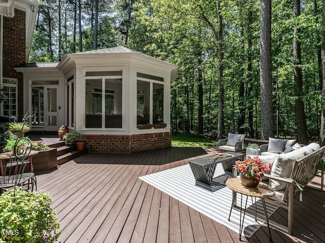 deck with an outdoor living space and a sunroom