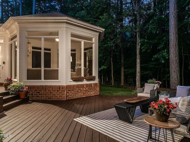 wooden deck featuring a sunroom