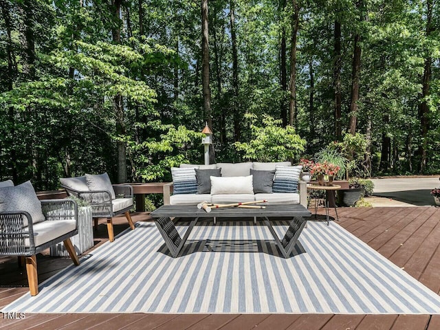 wooden terrace with an outdoor hangout area