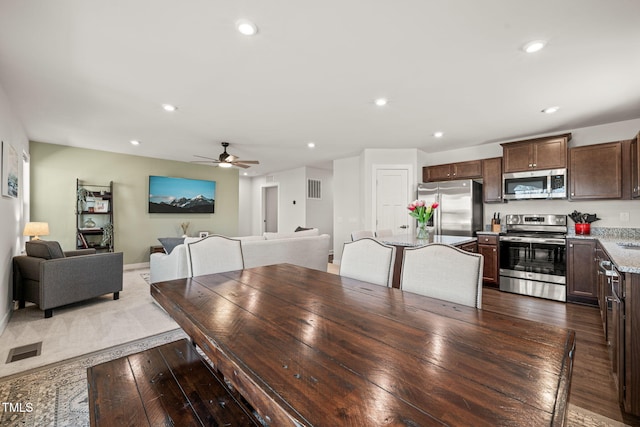 dining area featuring a ceiling fan, dark wood-style flooring, visible vents, and recessed lighting