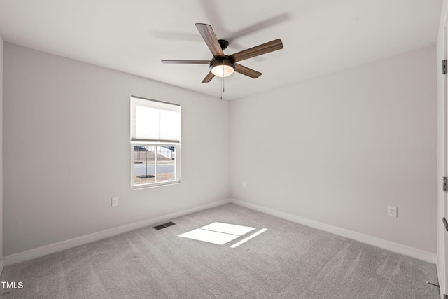 unfurnished room with light colored carpet, visible vents, ceiling fan, and baseboards