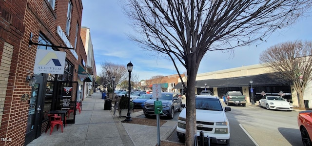 view of road with curbs, street lighting, and sidewalks