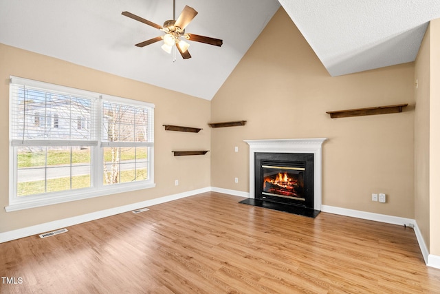 unfurnished living room featuring ceiling fan, high vaulted ceiling, and light hardwood / wood-style floors