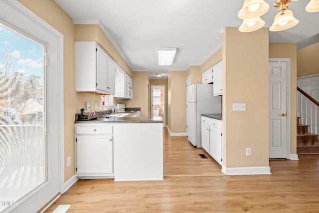 kitchen featuring white cabinetry, white appliances, light hardwood / wood-style flooring, and crown molding