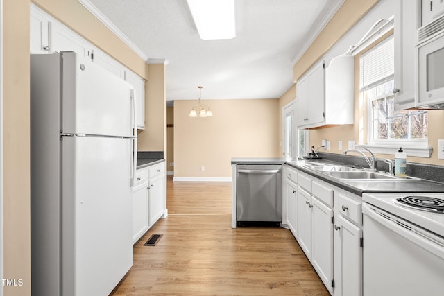 kitchen featuring white cabinets and white appliances