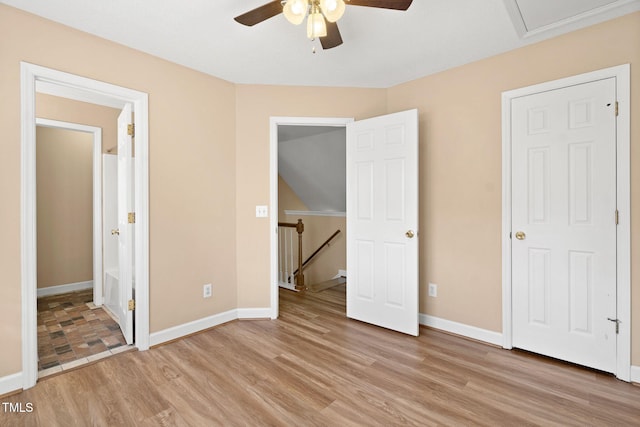 unfurnished bedroom with ceiling fan and light wood-type flooring