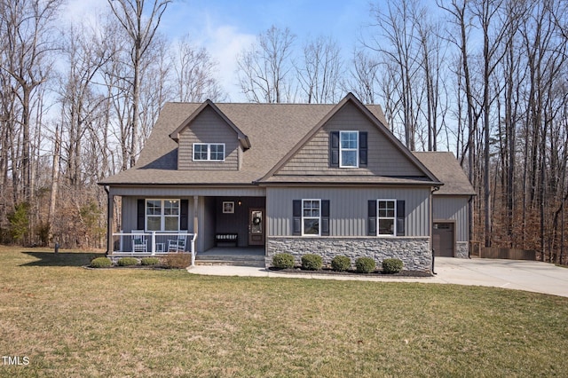 craftsman inspired home with a porch, a shingled roof, a front yard, stone siding, and driveway