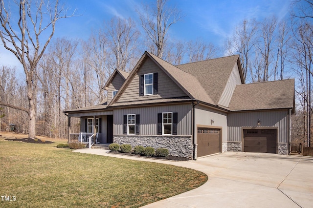 view of front of house with concrete driveway, stone siding, a front lawn, and an attached garage