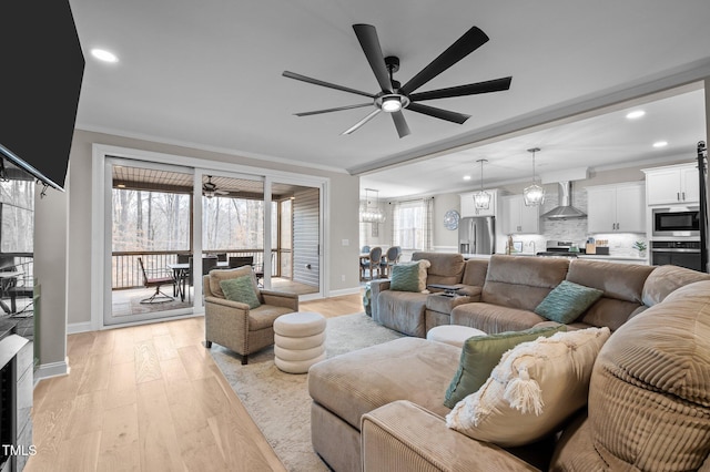 living area with recessed lighting, crown molding, light wood-style flooring, and ceiling fan