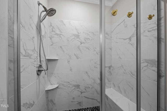 full bath with ornamental molding and a shower stall