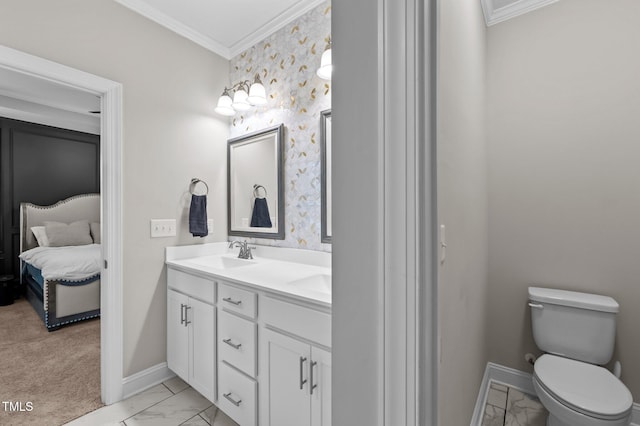 ensuite bathroom with double vanity, baseboards, ornamental molding, marble finish floor, and a sink