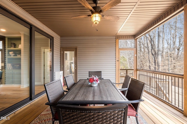 unfurnished sunroom featuring a ceiling fan