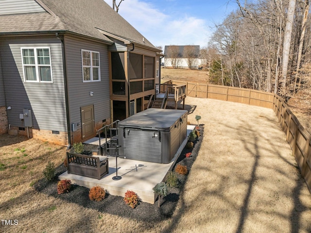 exterior space with a patio area, a fenced backyard, a sunroom, and a hot tub