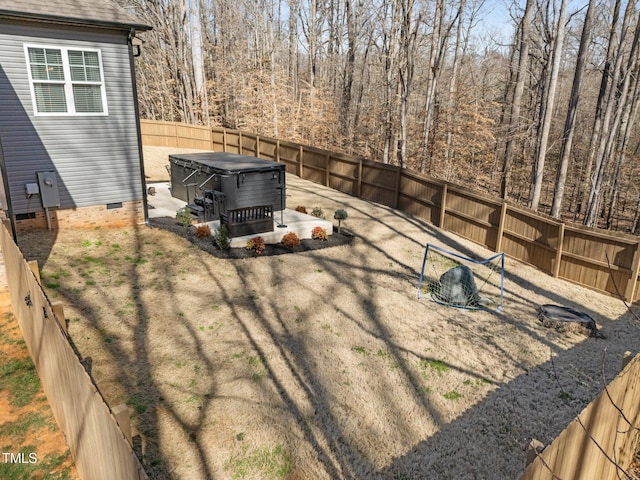 view of yard with a fenced backyard, a patio, and a hot tub