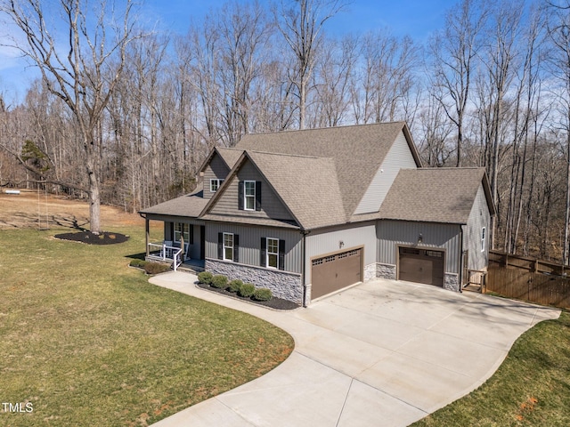 view of front facade featuring a porch, a garage, stone siding, concrete driveway, and a front lawn