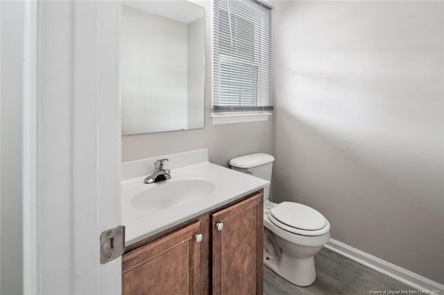 bathroom with vanity, hardwood / wood-style floors, and toilet