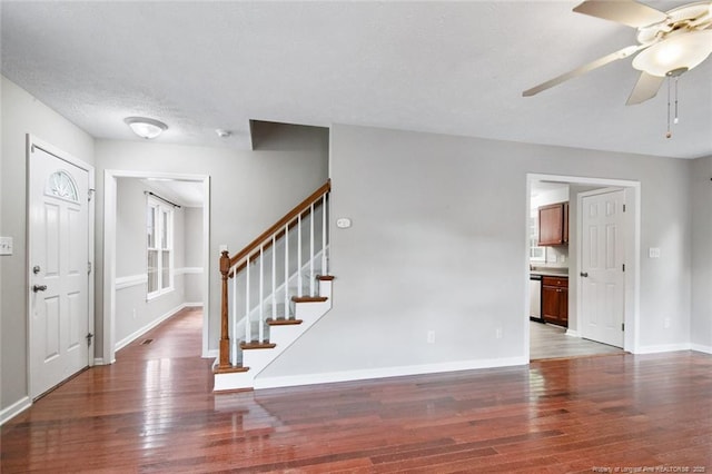 entrance foyer featuring ceiling fan, dark hardwood / wood-style flooring, and a textured ceiling