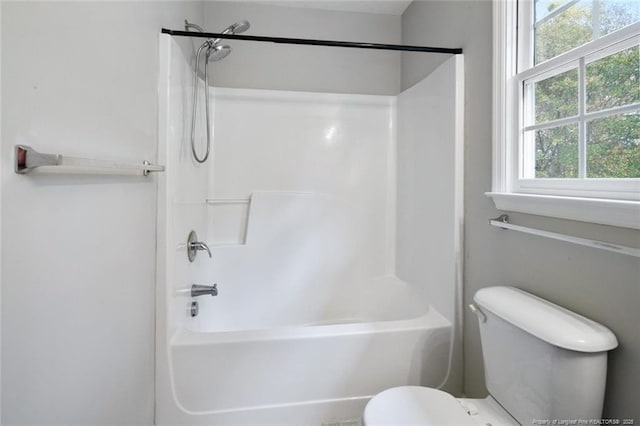 bathroom with shower / washtub combination and toilet