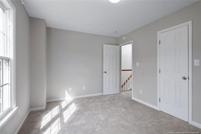 unfurnished bedroom with light colored carpet