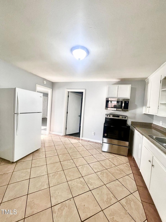 207 Faison Ave, Fayetteville, NC 28304 - kitchen featuring open shelves, stainless steel appliances, white cabinets, and light tile patterned floors