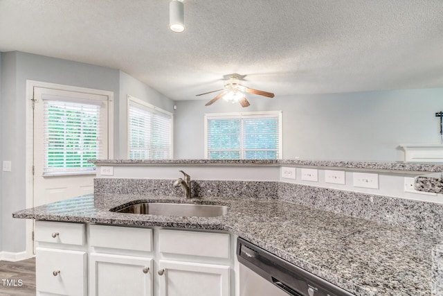 kitchen featuring sink, ceiling fan, light stone countertops, a textured ceiling, and white cabinets