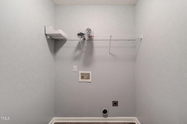 laundry area with hookup for a washing machine, electric dryer hookup, and a textured ceiling