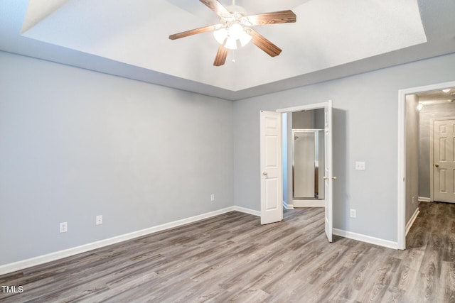 unfurnished bedroom featuring hardwood / wood-style flooring and ceiling fan