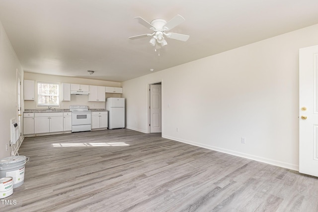 unfurnished living room featuring sink, light hardwood / wood-style floors, and ceiling fan