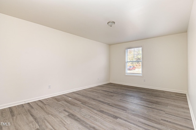 unfurnished room featuring hardwood / wood-style flooring